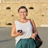 Outdoor portrait of smiling middle-aged woman walking through an old town